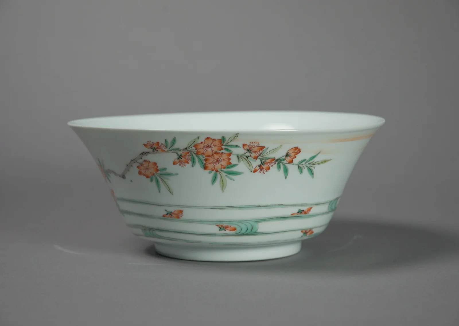 Chinese porcelain bowl from the late 17th or early 18th century painted with flowering branches over waves