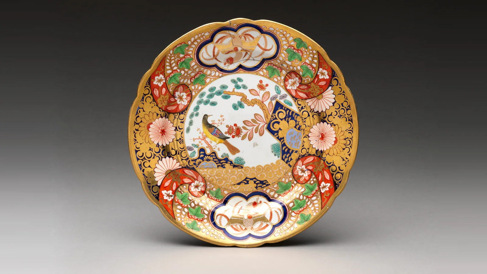 Spode porcelain plate from about 1815 with gilded Imari-style decoration of a bird and flowers